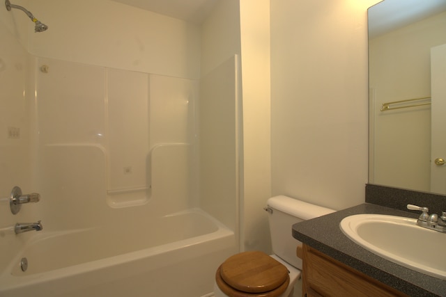 full bath with toilet, vanity, and  shower combination