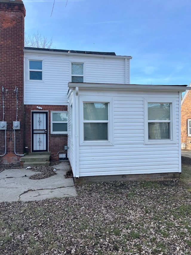 back of house with brick siding