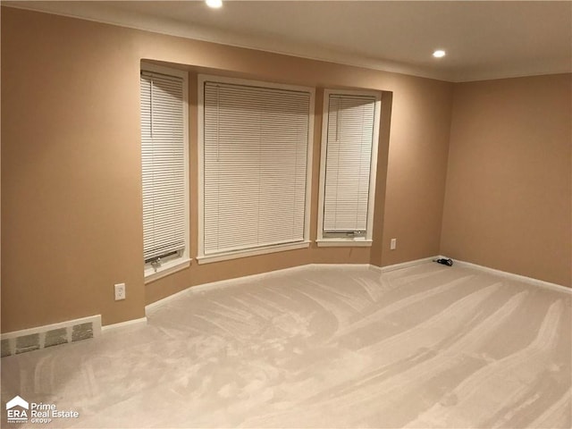 carpeted spare room with recessed lighting and baseboards