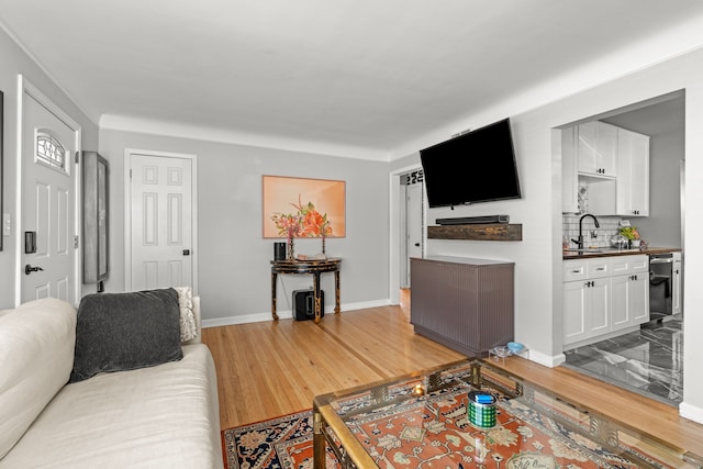 living room with baseboards and light wood-style floors