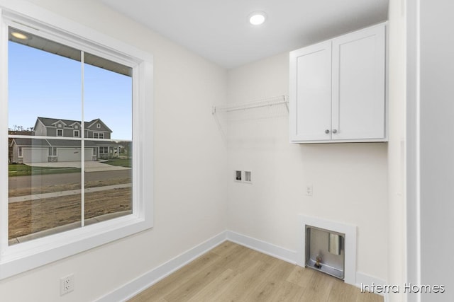 laundry room with light wood finished floors, baseboards, washer hookup, recessed lighting, and cabinet space