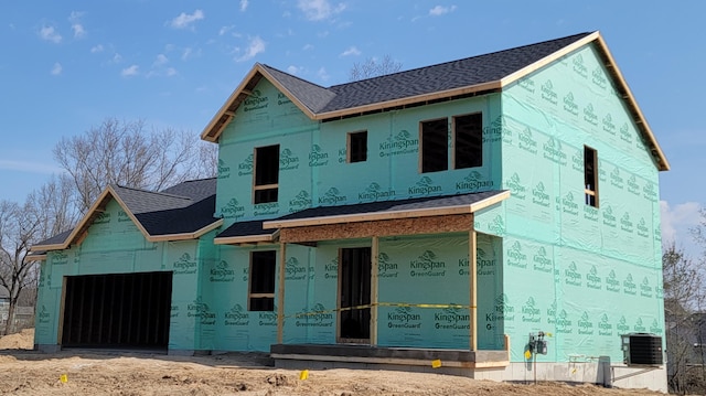 unfinished property with cooling unit, a shingled roof, and a garage
