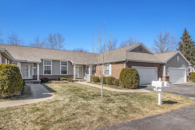 single story home with driveway, an attached garage, a shingled roof, a front lawn, and brick siding