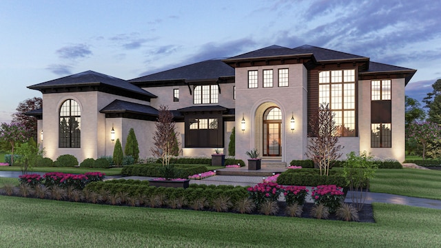 view of front of home featuring brick siding and a front lawn