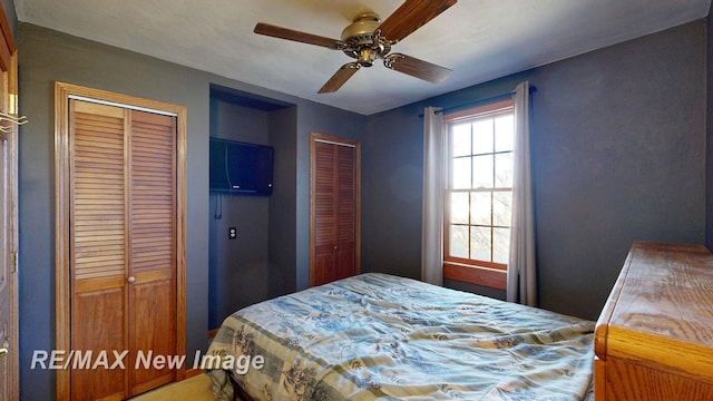 bedroom featuring two closets and ceiling fan