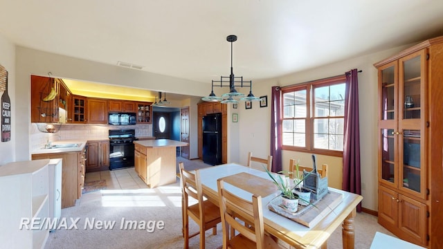 dining area with visible vents and light colored carpet