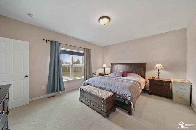 bedroom with visible vents, baseboards, and light colored carpet