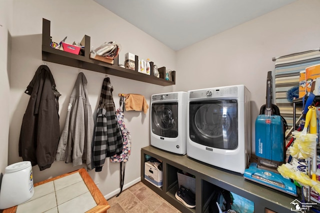 laundry room featuring baseboards, separate washer and dryer, and laundry area