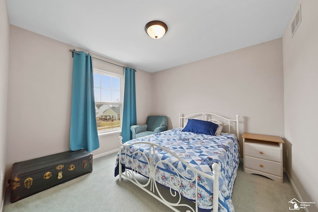 carpeted bedroom featuring visible vents and baseboards