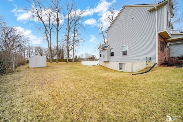 view of yard with a storage shed and an outbuilding