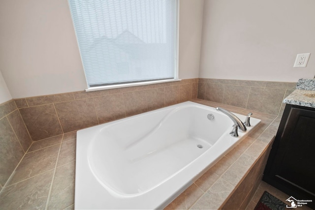 full bathroom with a garden tub and vanity