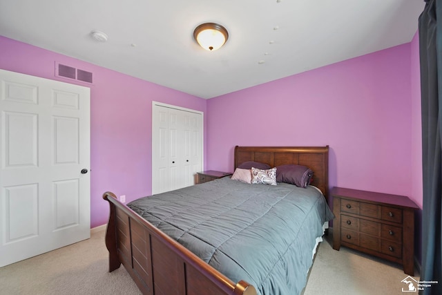 bedroom featuring light carpet, visible vents, and a closet