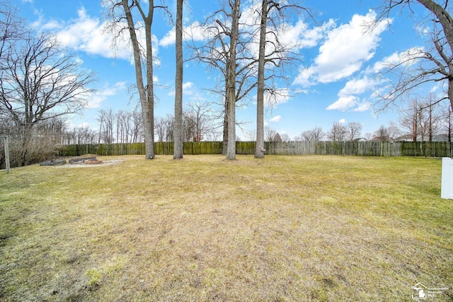 view of yard featuring a fire pit and fence