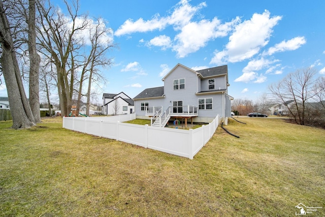 back of property with a lawn and a fenced backyard