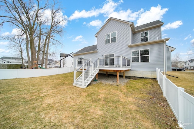 rear view of house featuring a yard, a fenced backyard, stairway, and a deck