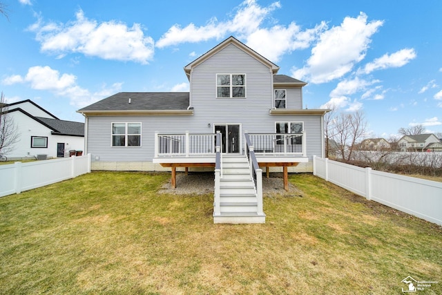 rear view of property with a wooden deck, a lawn, a fenced backyard, and stairway