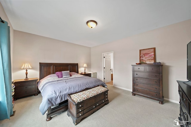 bedroom featuring light colored carpet and baseboards