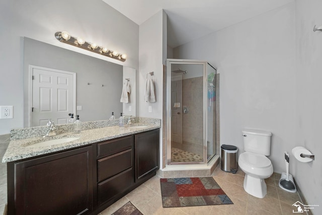 full bath featuring double vanity, toilet, a stall shower, and a sink