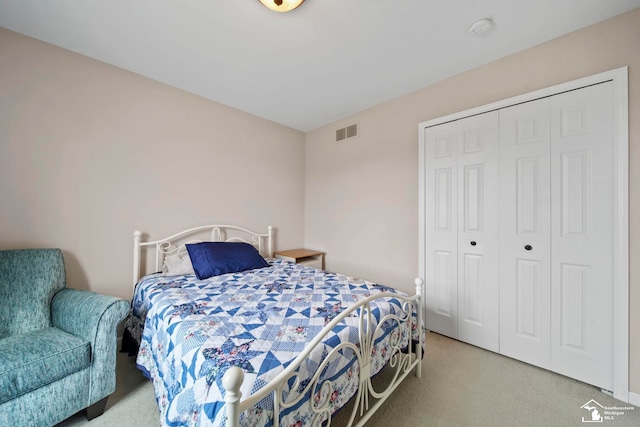 carpeted bedroom featuring visible vents and a closet