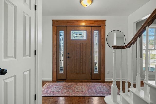 entrance foyer with stairway and baseboards