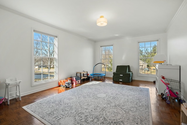 recreation room with baseboards and ornamental molding