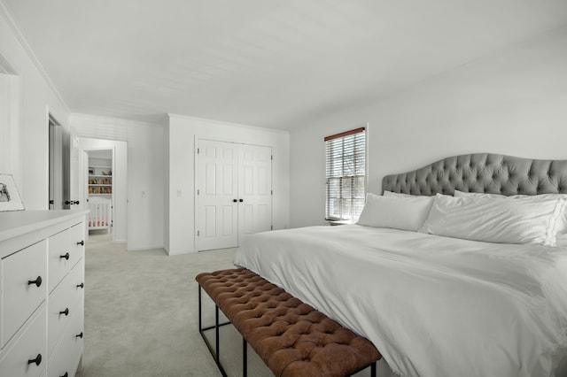 bedroom with a closet, light colored carpet, baseboards, and ornamental molding