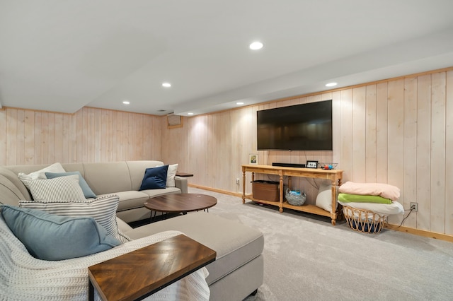 carpeted living area with recessed lighting, wood walls, and baseboards