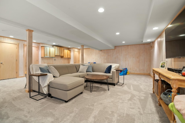 living area with light carpet, wooden walls, recessed lighting, and baseboards