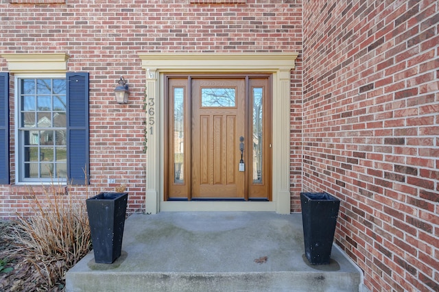 view of exterior entry with brick siding