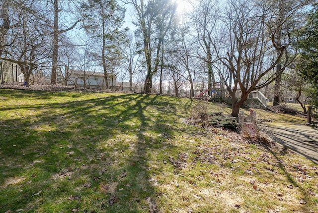 view of yard with a wooden deck and stairs