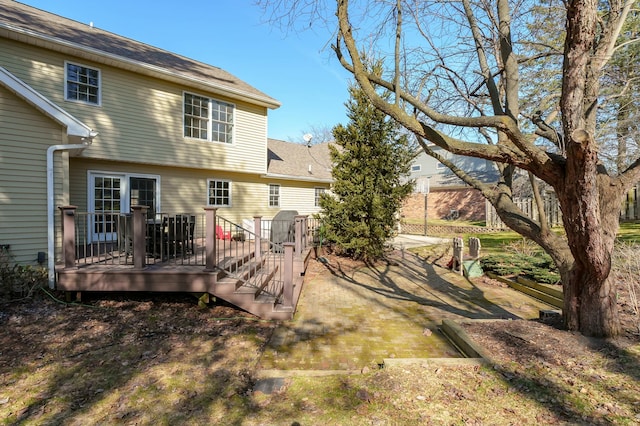 back of property featuring a wooden deck