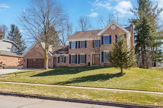 view of front of home with driveway, a front lawn, a garage, brick siding, and a chimney