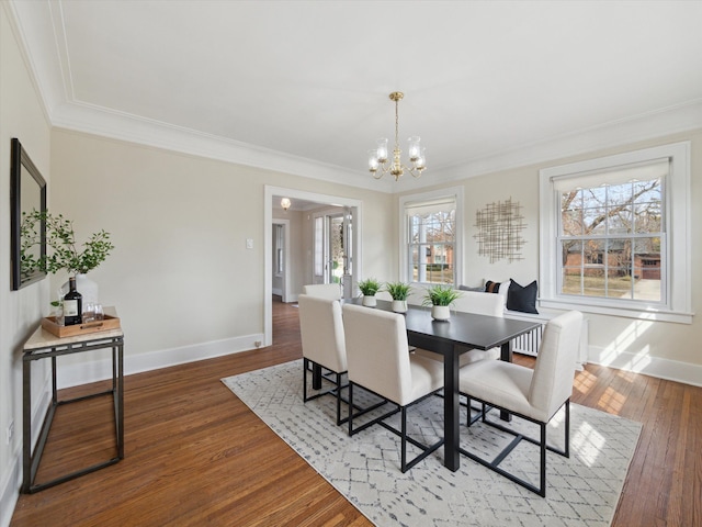 dining area featuring baseboards, hardwood / wood-style floors, and ornamental molding