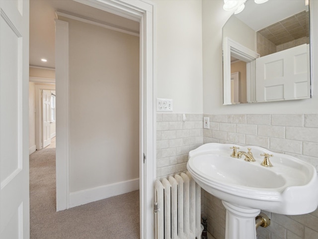 bathroom featuring tile walls and radiator heating unit