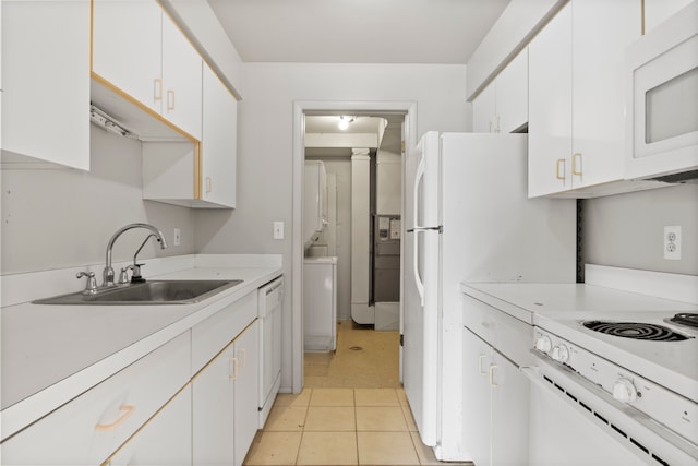 kitchen with white cabinets, white appliances, light countertops, and a sink