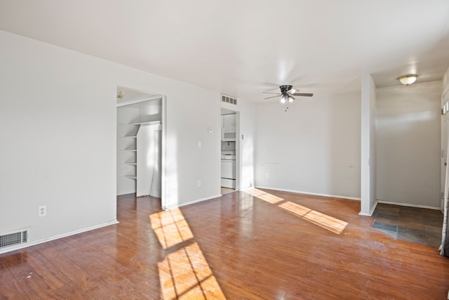 spare room featuring wood finished floors, visible vents, and ceiling fan