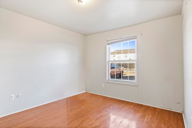 spare room featuring wood finished floors