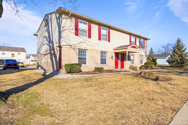 view of front of house with brick siding and a front yard