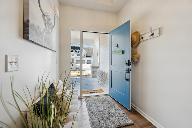 entryway featuring baseboards and wood finished floors