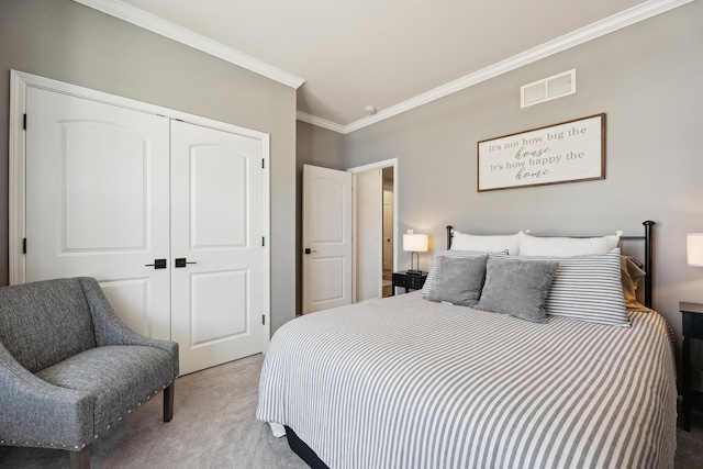 carpeted bedroom featuring visible vents, a closet, and ornamental molding