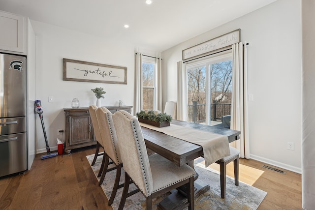 dining space with recessed lighting, visible vents, baseboards, and wood finished floors