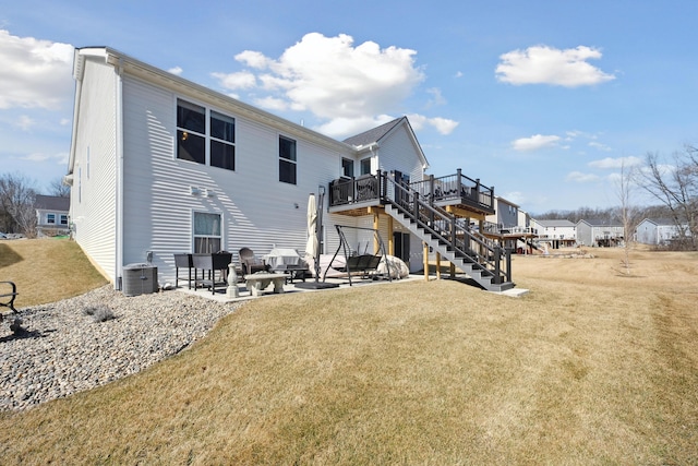 rear view of house featuring a wooden deck, stairs, a lawn, cooling unit, and a patio area