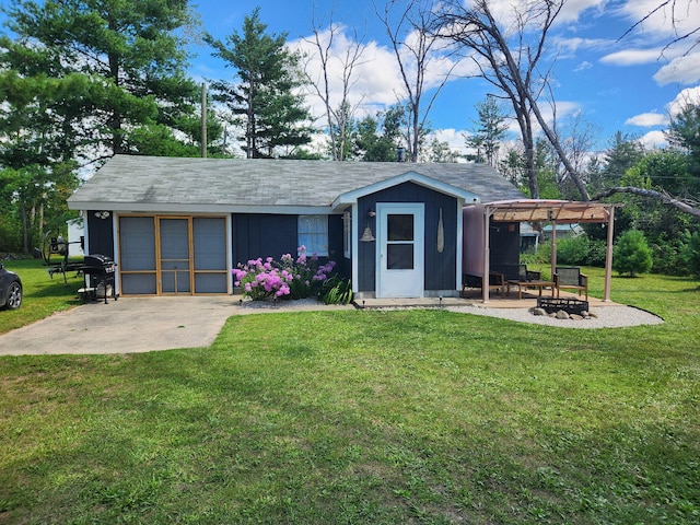 exterior space with an attached garage, an outdoor fire pit, an outbuilding, driveway, and a pergola