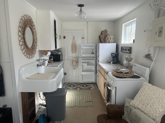 kitchen with light countertops, electric range, concrete block wall, and a sink