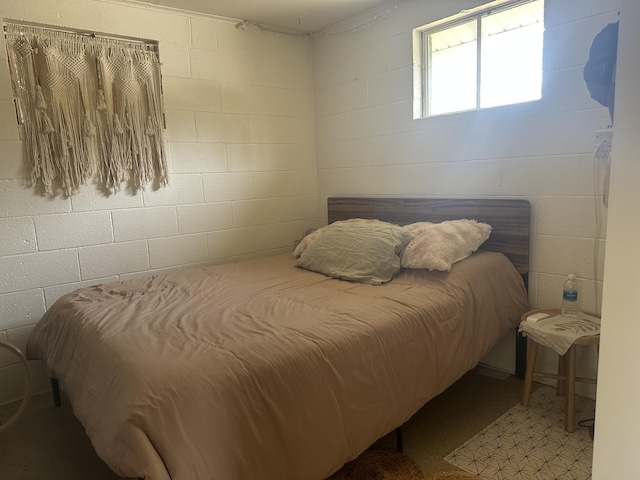 bedroom with concrete block wall