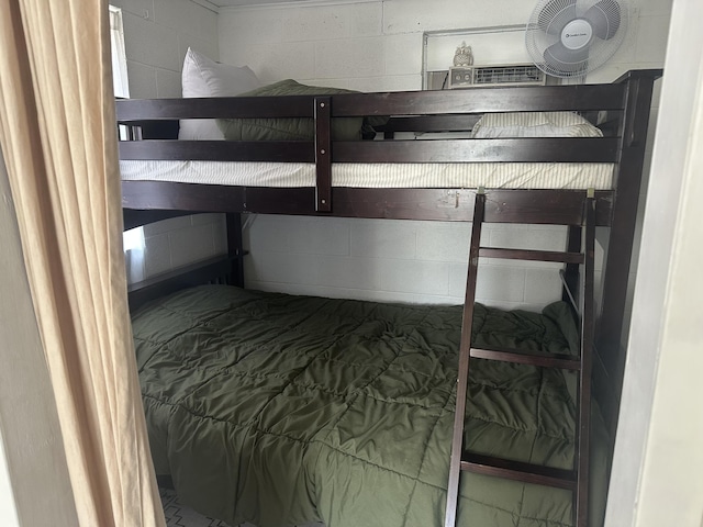 bedroom with concrete block wall