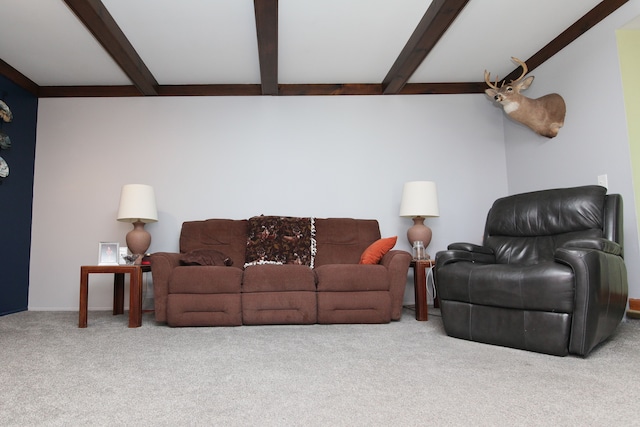 living room with beamed ceiling and carpet floors