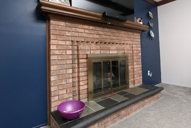 room details with carpet flooring, a brick fireplace, and baseboards