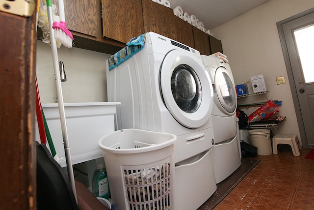 washroom with cabinet space and washing machine and clothes dryer