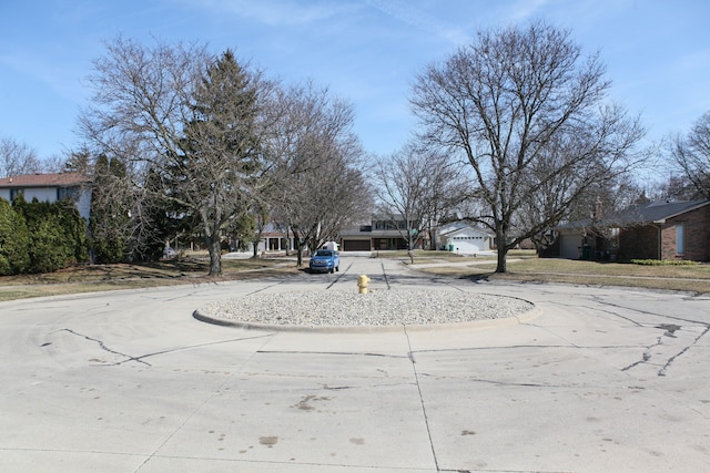 view of street featuring a residential view and curbs